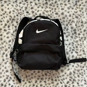 This is a black Nike mini backpack